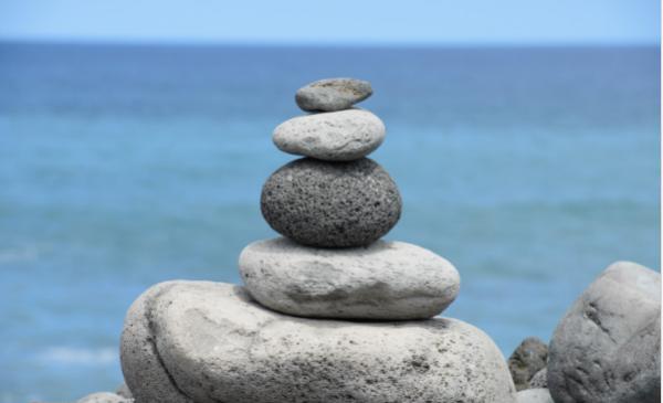Stones neatly stacked on top of each other at a beach